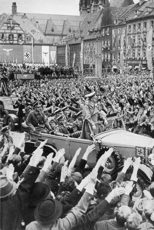 Hitler is driven through the crowd in Cheb